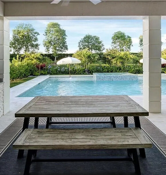 Covered patio dining area overlooking pool in Cascata at MiraLago