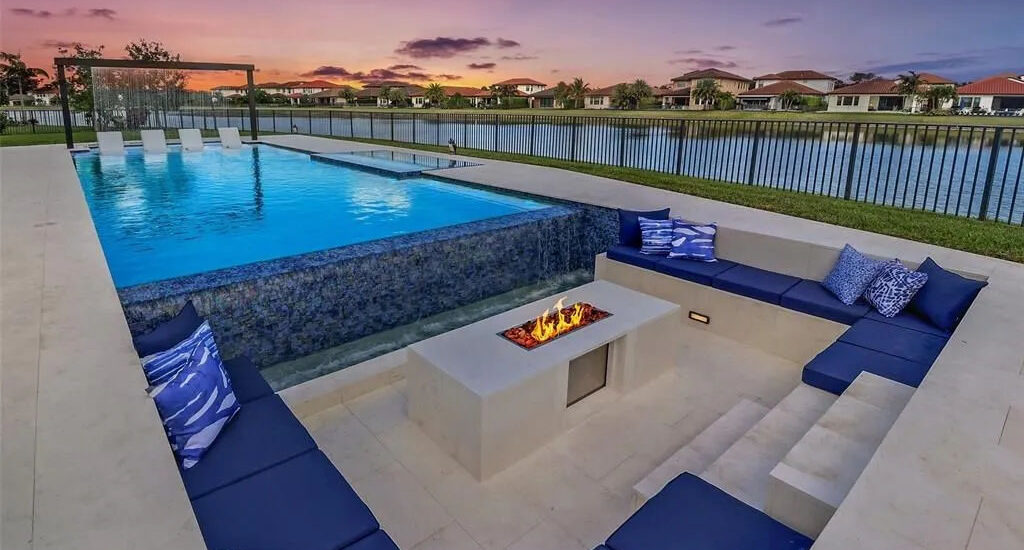 Luxury custom pool with sunken seating area and fire pit in Parkland, Florida