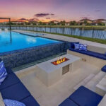 Luxury custom pool with sunken seating area and fire pit in Parkland, Florida