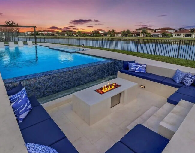Luxury custom pool with sunken seating area and fire pit in Parkland, Florida
