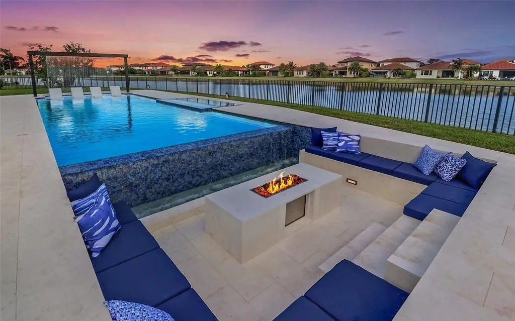 Luxury custom pool with sunken seating area and fire pit in Parkland, Florida